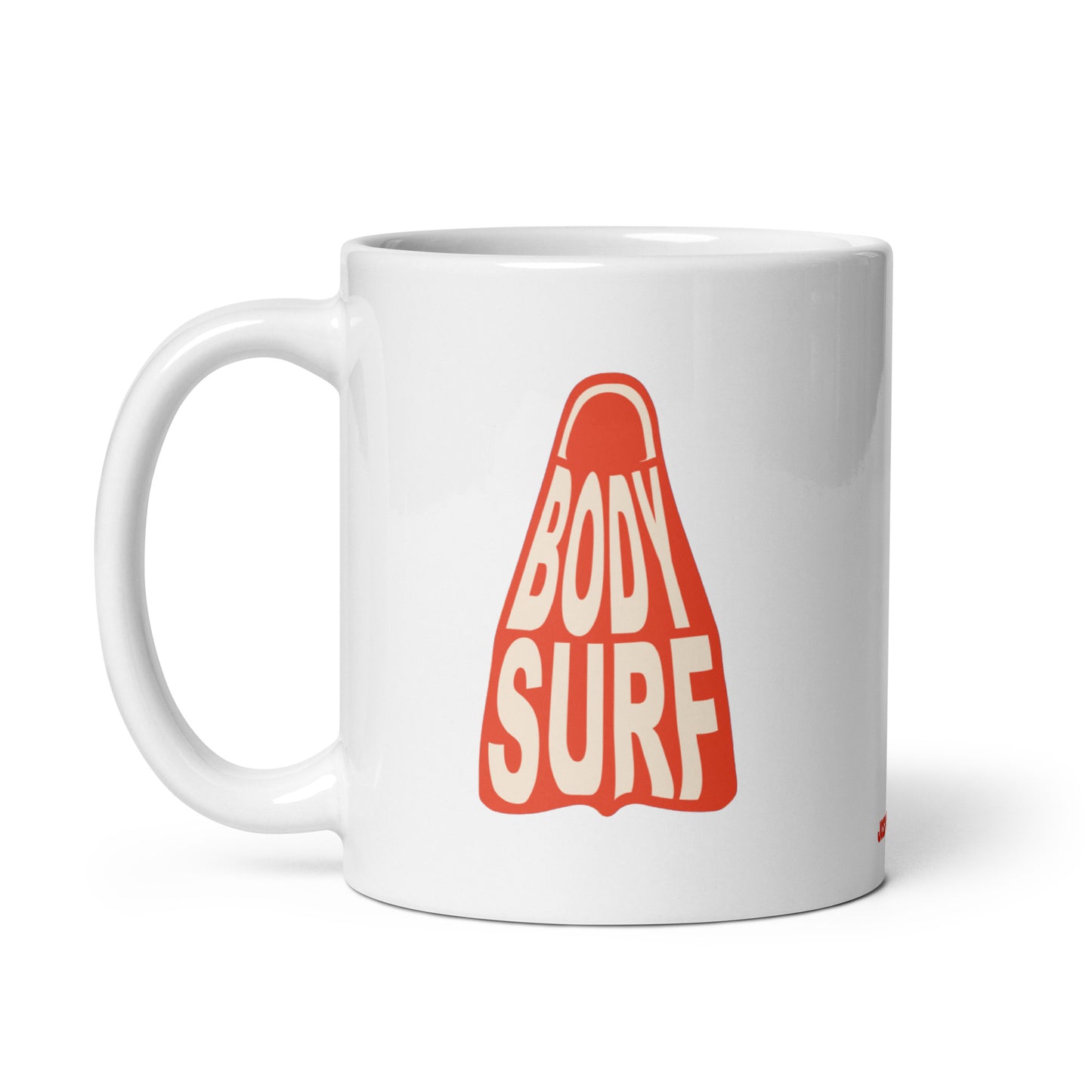 Playful mug perfect for bodysurfers or ocean lovers, showcasing a white, shiny ceramic base with a cool bodysurf fin detail in multiple colors. Peach burnt orange